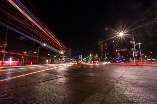 Dynamic long exposure of traffic light trails at night in downtown Mexico City.