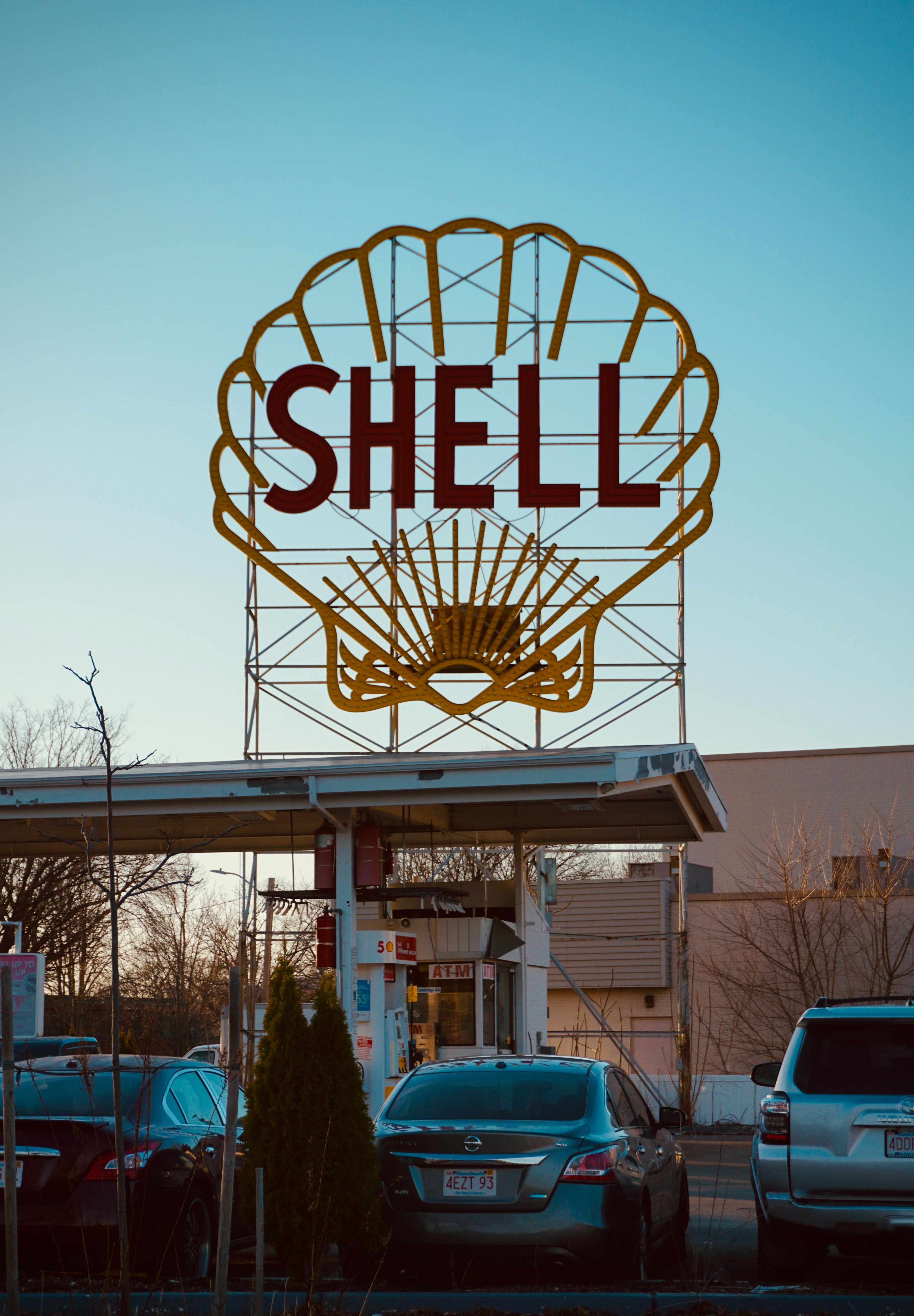 Shell Gas Station Sign Against Blue Sky · Free Stock Photo