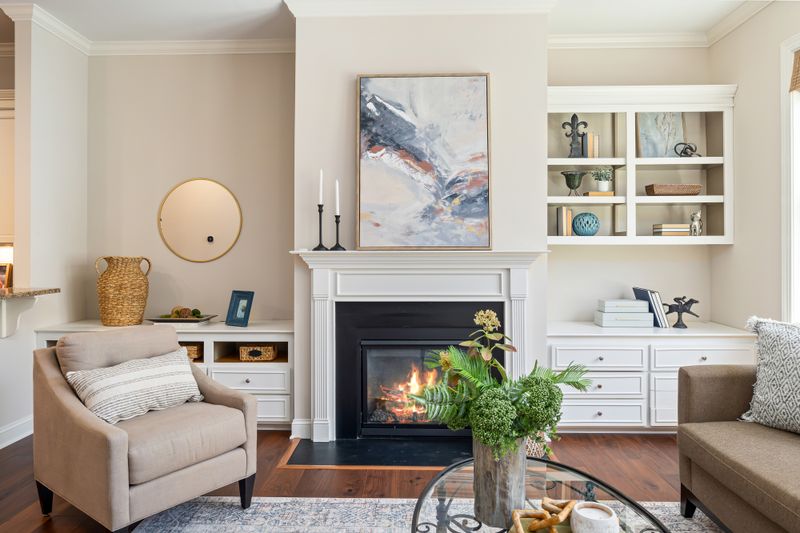 Elegant living room featuring a modern fireplace, art, and stylish furniture for a cozy ambiance.