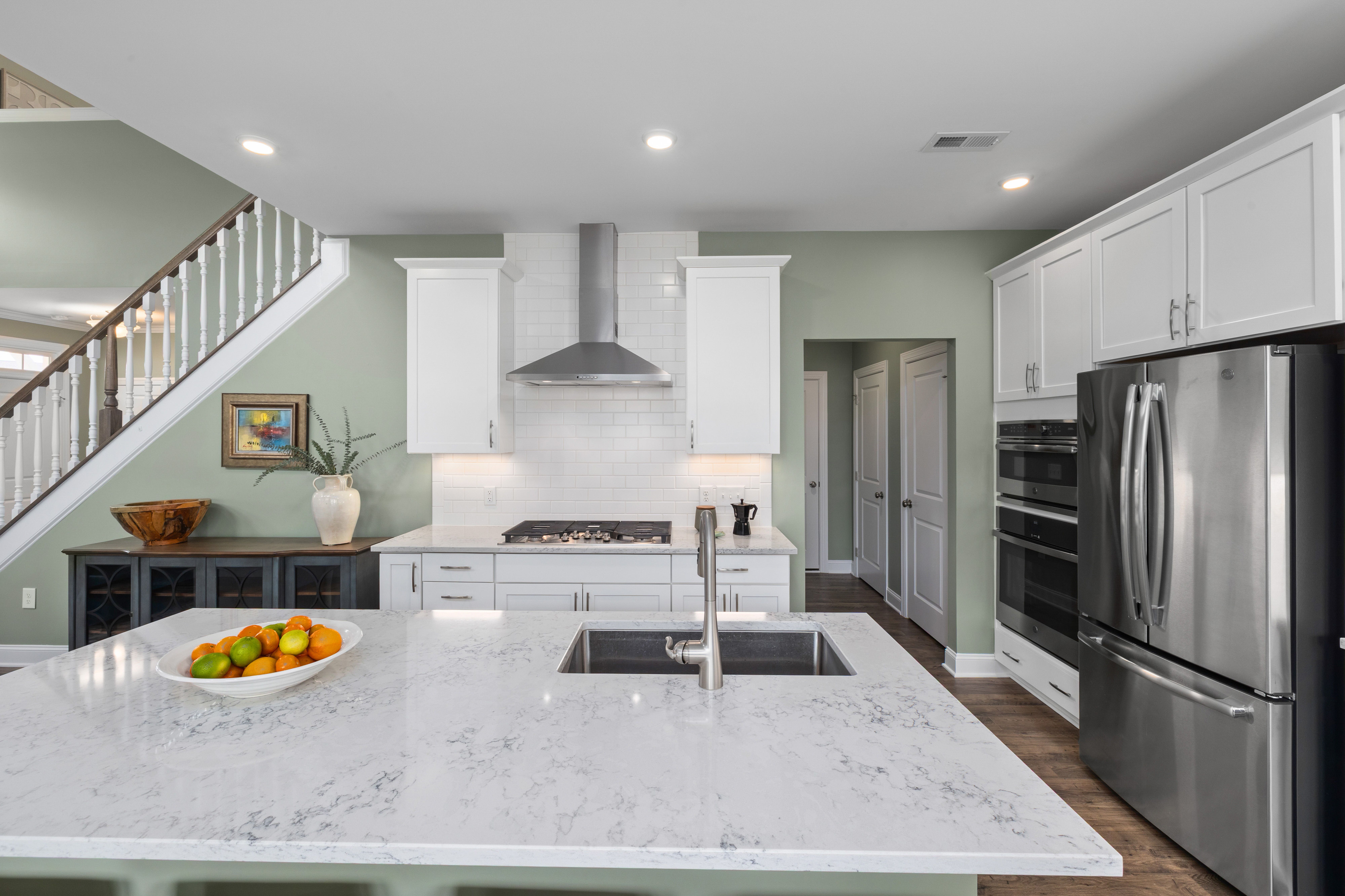 Close-up of a contemporary kitchen with a marble island and stainless steel appliances