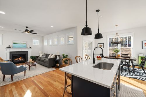 Free Bright open-concept living room and dining space featuring modern interior design. Stock Photo