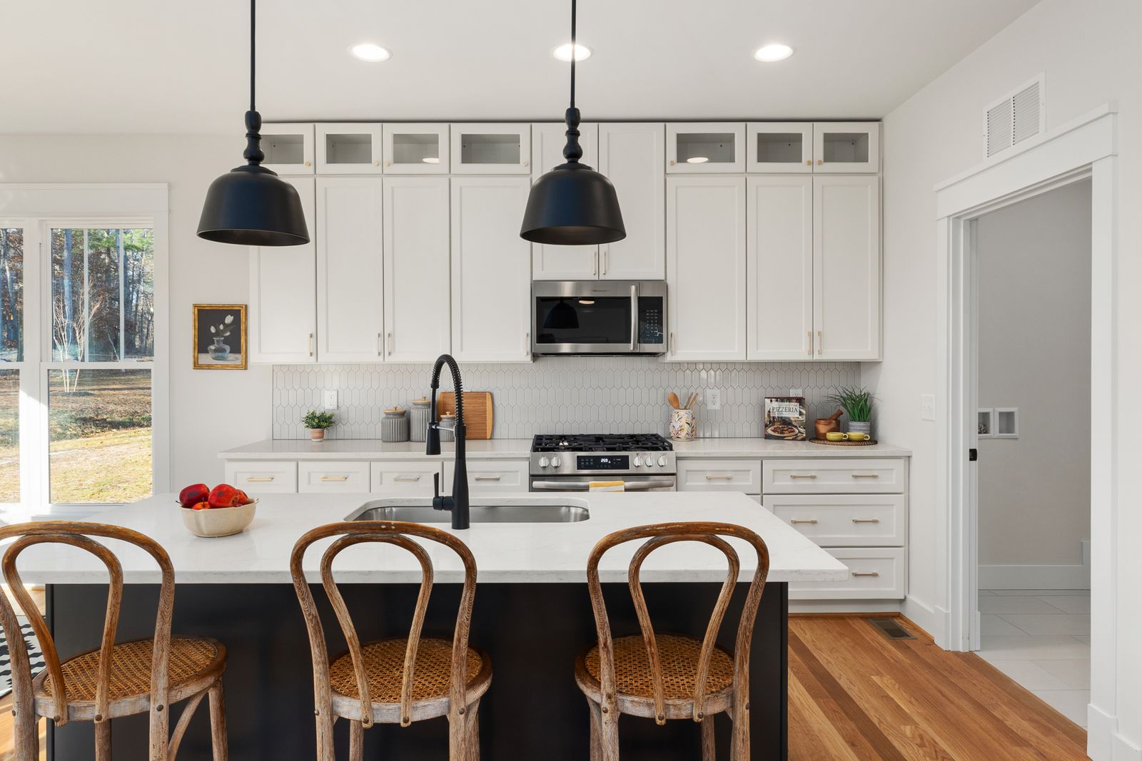 Modern bright kitchen with white cabinets and central island