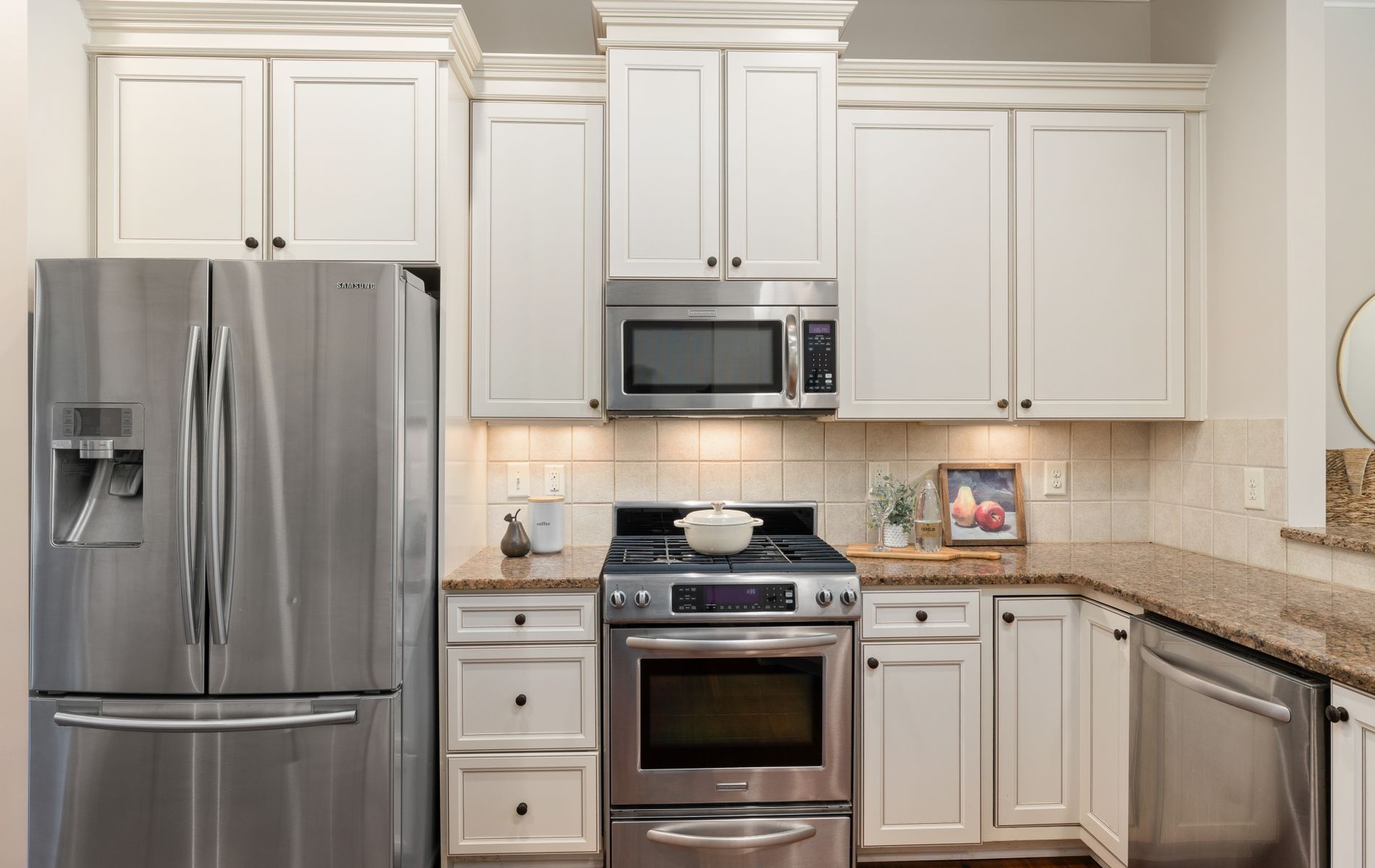 Kitchen appliance installation with stainless steel range and refrigerator in Orange County