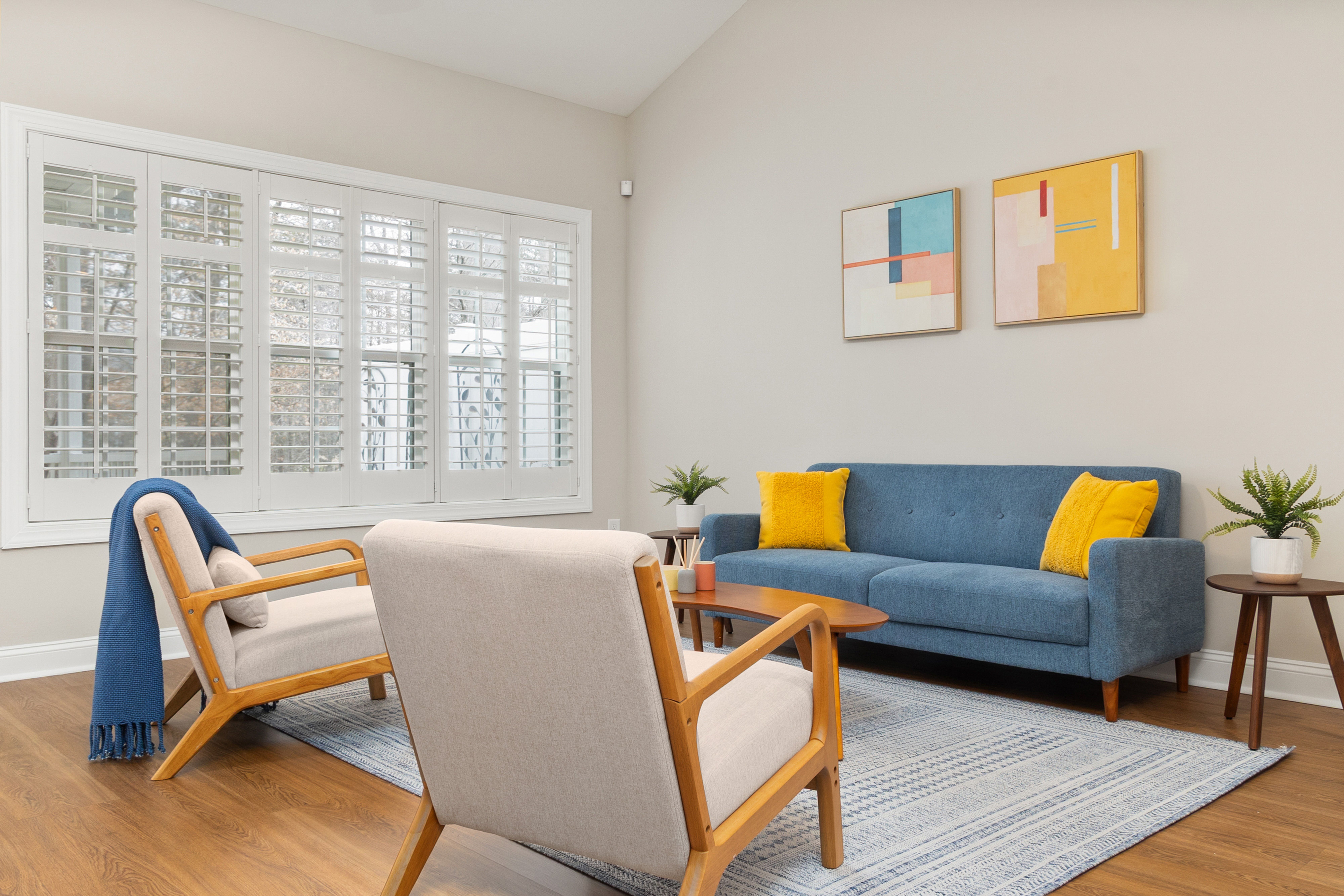 Modern Living Room with Blue Sofa and Abstract Art · Free Stock Photo