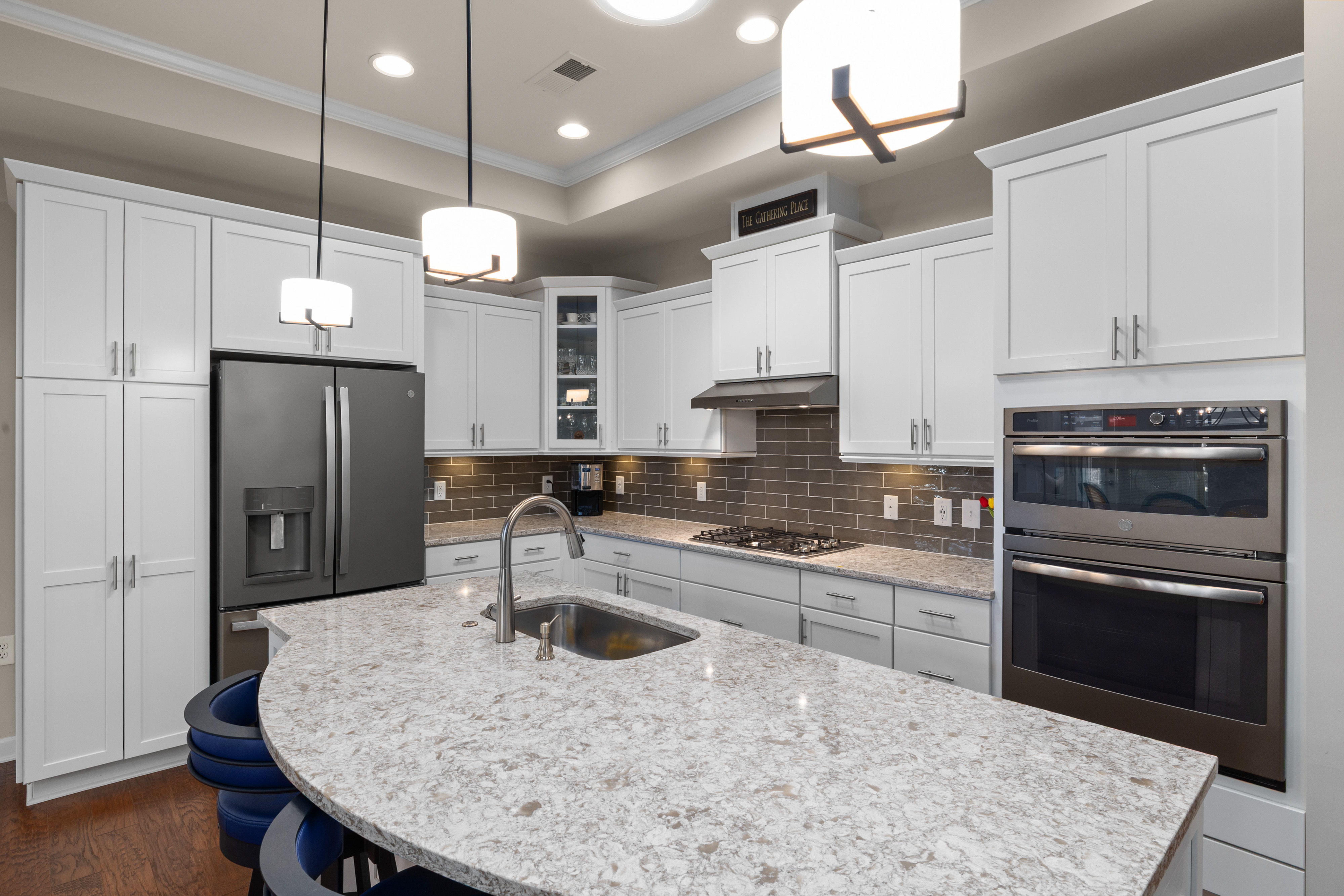 Loft kitchen featuring granite countertops and stainless steel appliances - 2 bedroom loft apartments