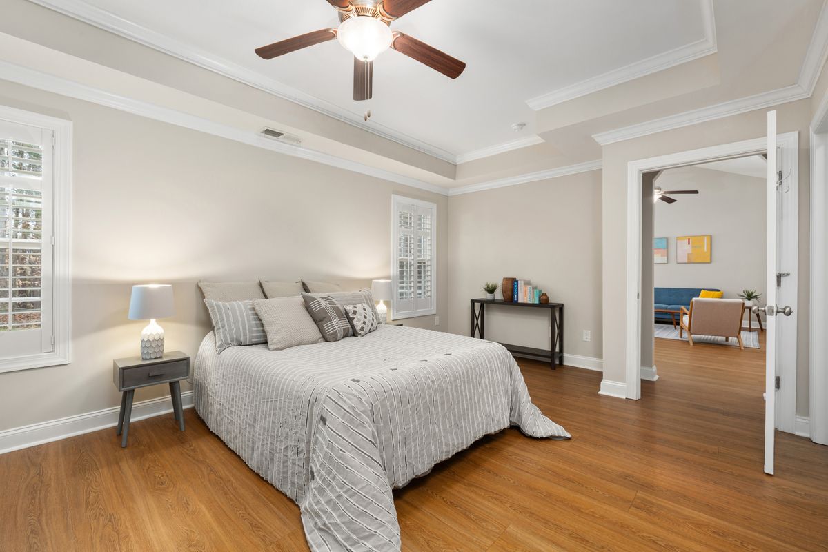 Circular Cove Ceiling with LED Strip Lighting and Ceiling Fan in a Dark Bedroom Hero