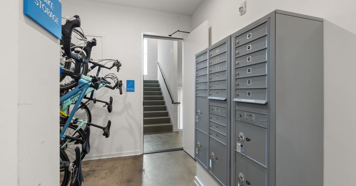 Indoor bike storage and mailroom with lockers, modern and organized.
