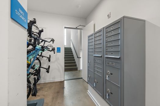 Indoor bike storage and mailroom with lockers, modern and organized.