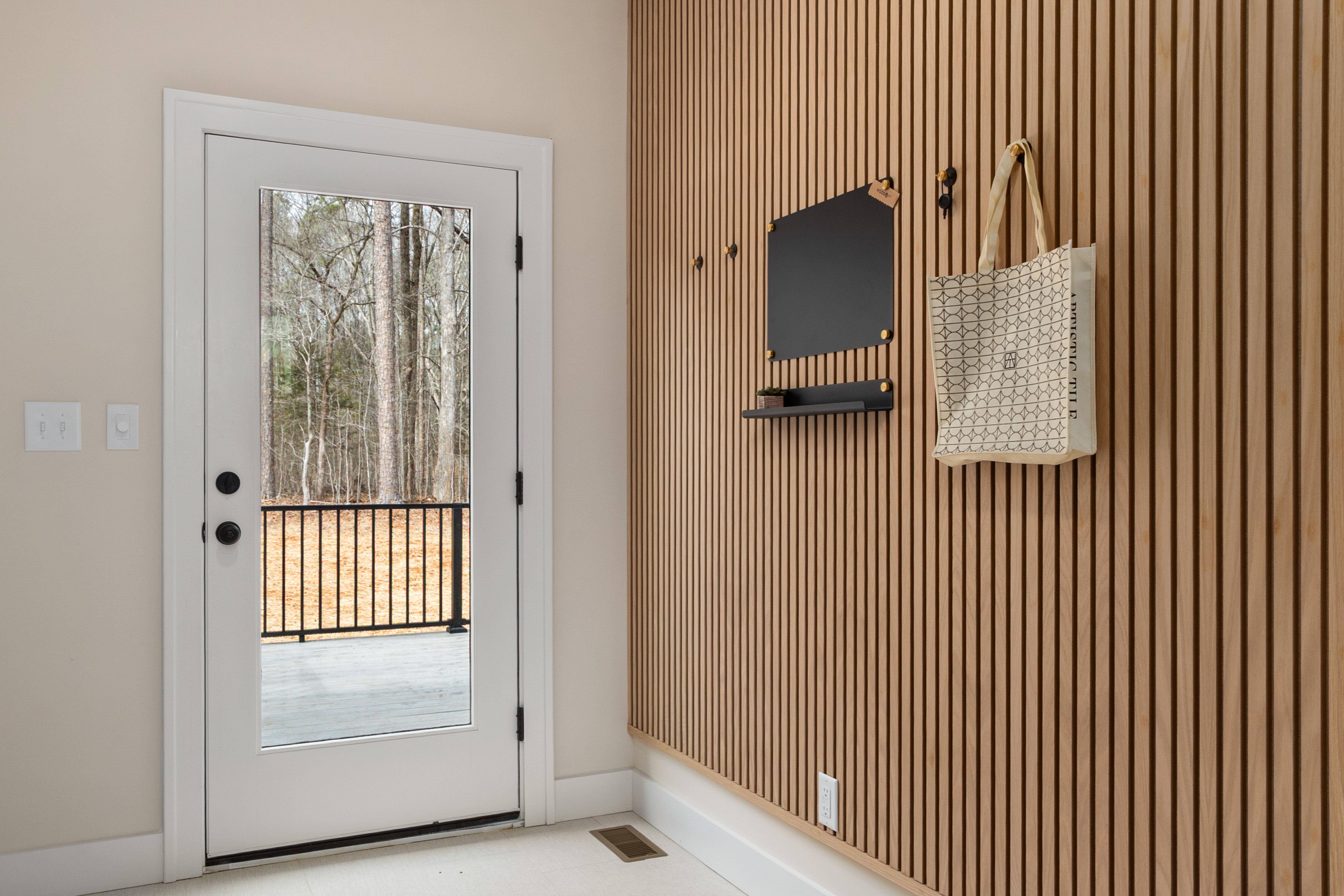Modern Interior with Wood Paneling and Glass Door · Free Stock Photo