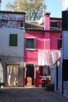 Vividly colored houses in Burano, Italy, displaying traditional Venetian architecture.