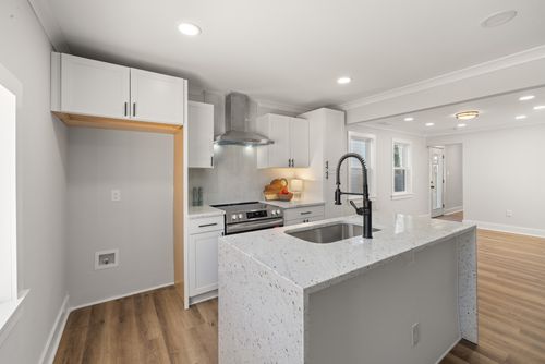 Free Stylish kitchen featuring granite countertops, stainless steel appliances, and hardwood flooring. Stock Photo
