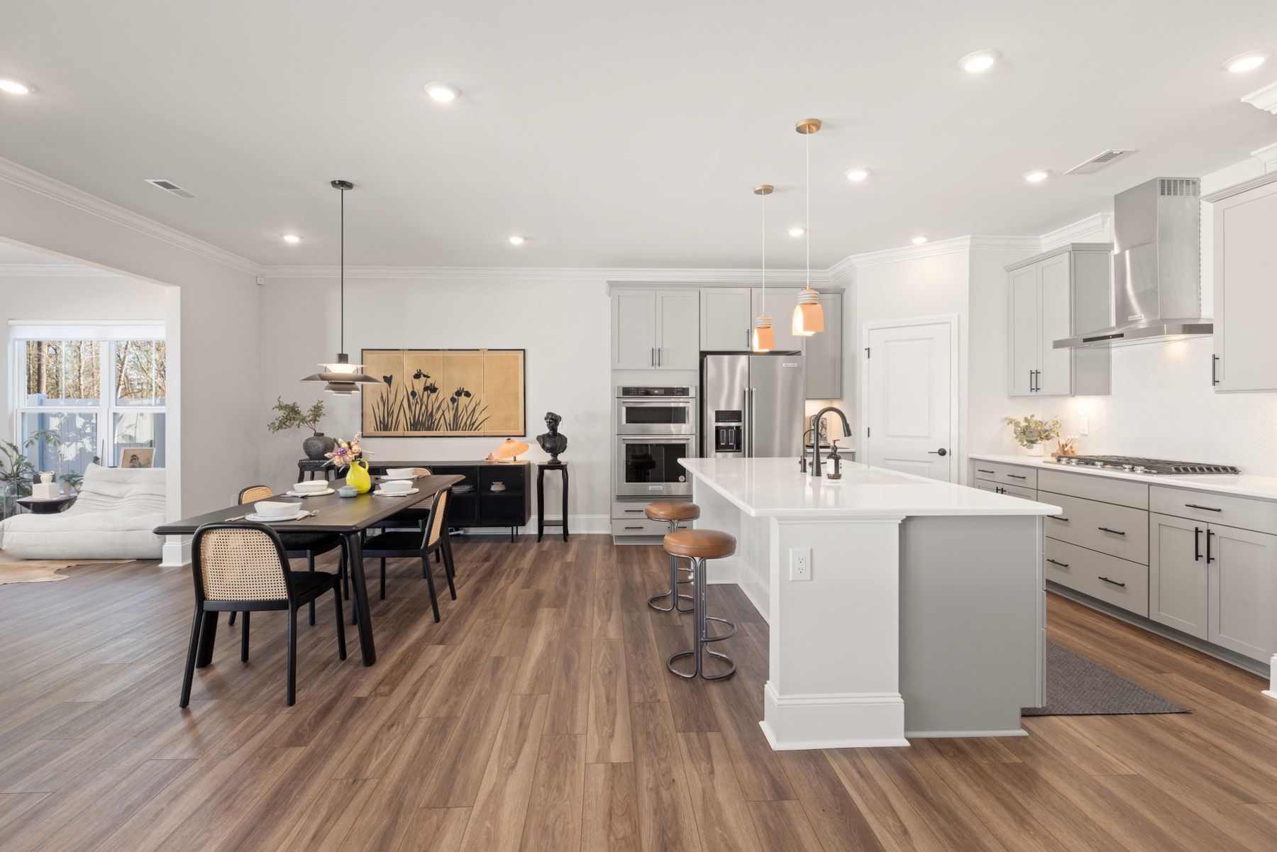 Spacious open-plan kitchen with island countertop and adjoining dining table in a connected layout