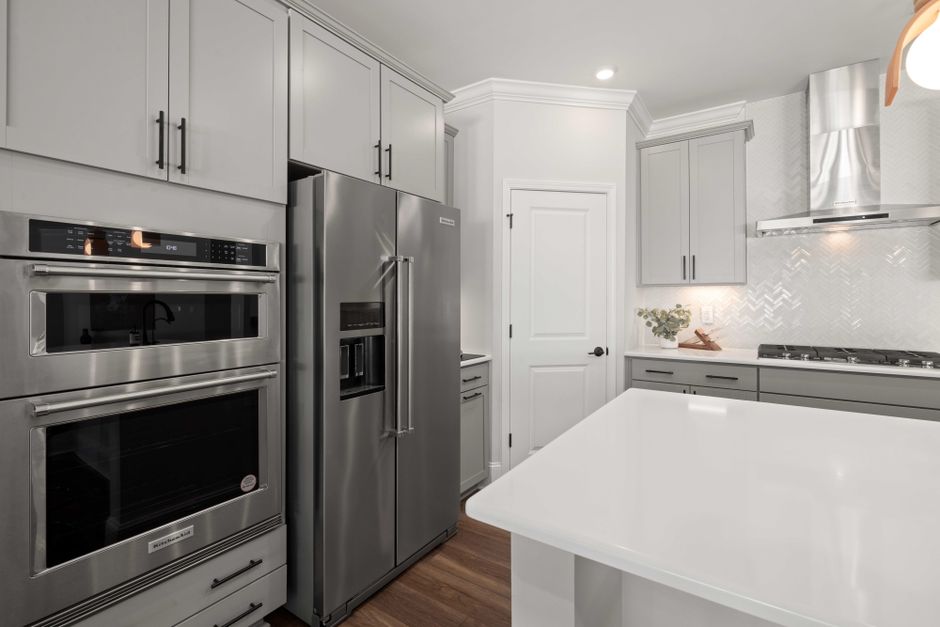 high-end kitchen with stainless steel appliances and quartz countertops - apartment amenities high-end kitchen with stainless steel appliances and quartz countertops - apartment amenities