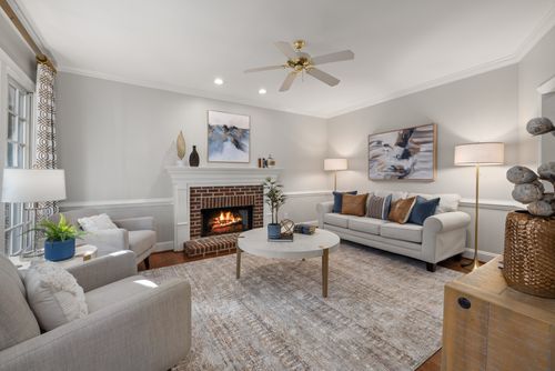 Free A cozy modern living room featuring a fireplace, elegant sofa, and tasteful decor. Stock Photo