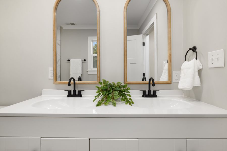 Custom double sink vanity with quartz countertop installed in Las Flores Ridge master bathroom