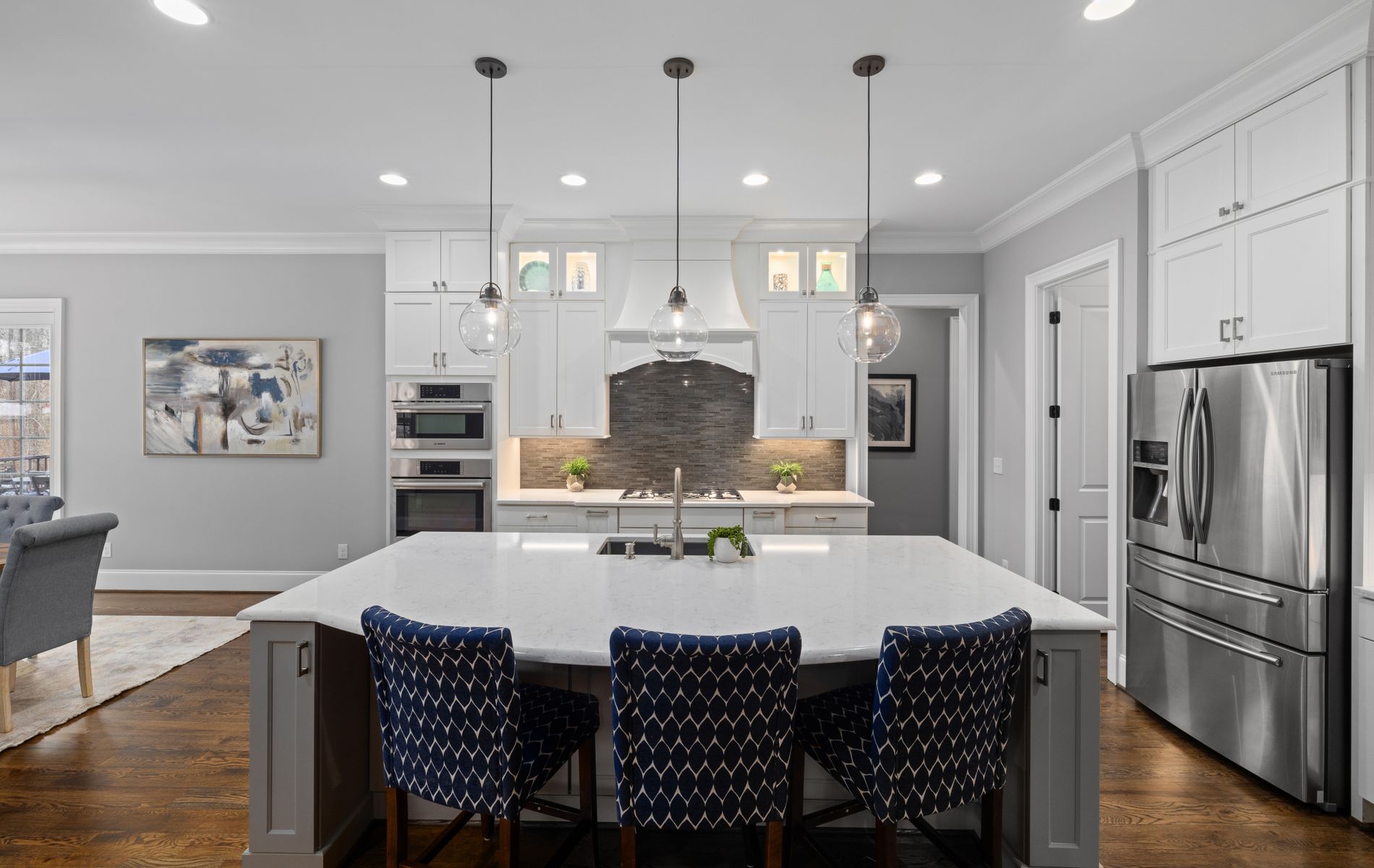 Newly remodeled luxury kitchen with white cabinets and large island in an Orange County home