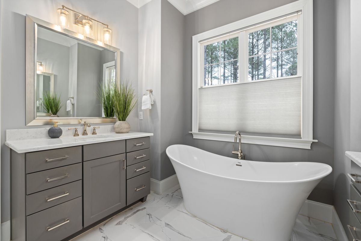 Warm modern bathroom with freestanding bath and vanity