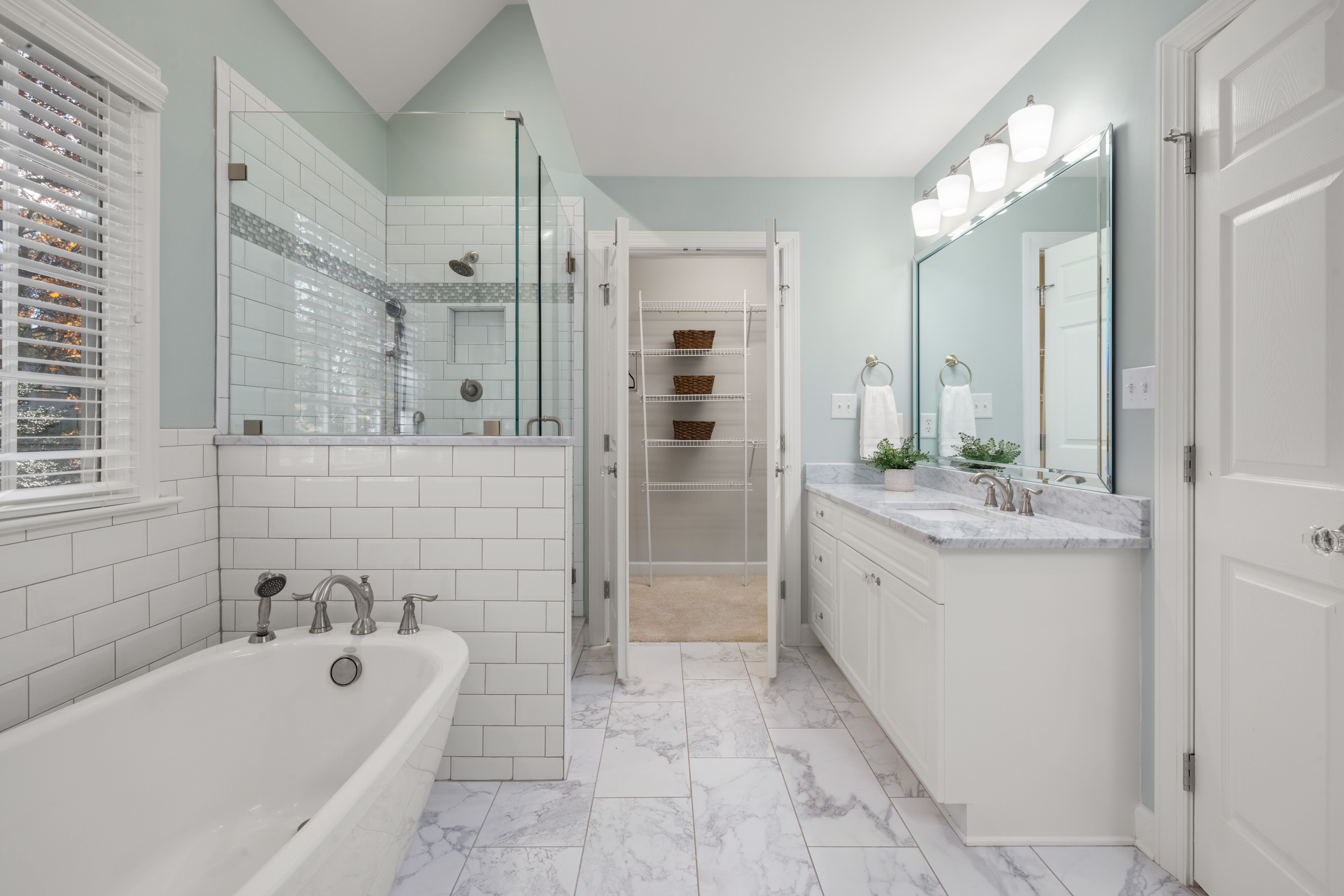 Bathroom renovation in progress with cost estimation charts and materials spread out on a San Jose remodel project table