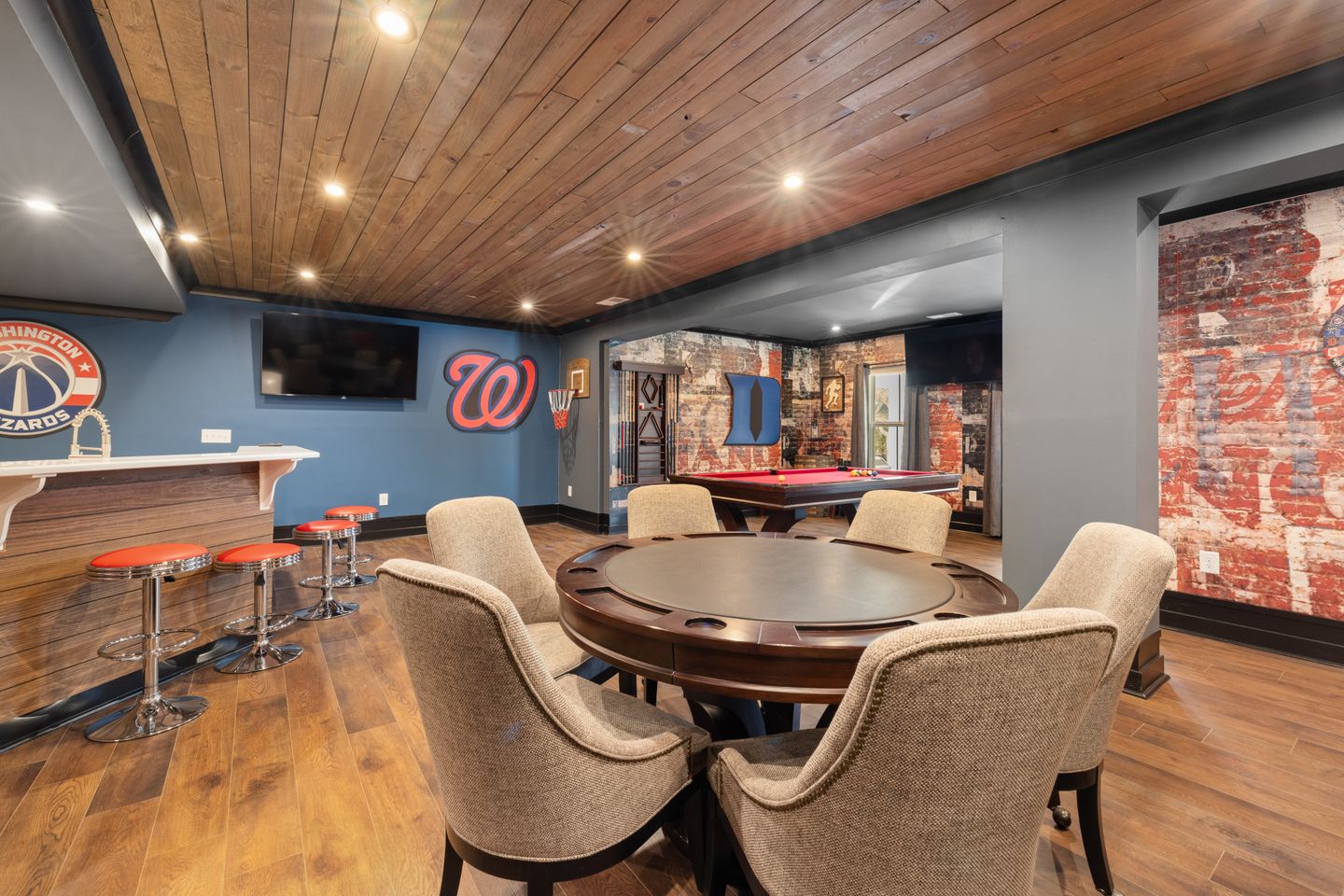 Modern basement game room with bar, seating, and pool table for spring addition contractor projects in Guelph. Modern basement game room with bar, seating, and pool table for spring addition contractor projects in Guelph.