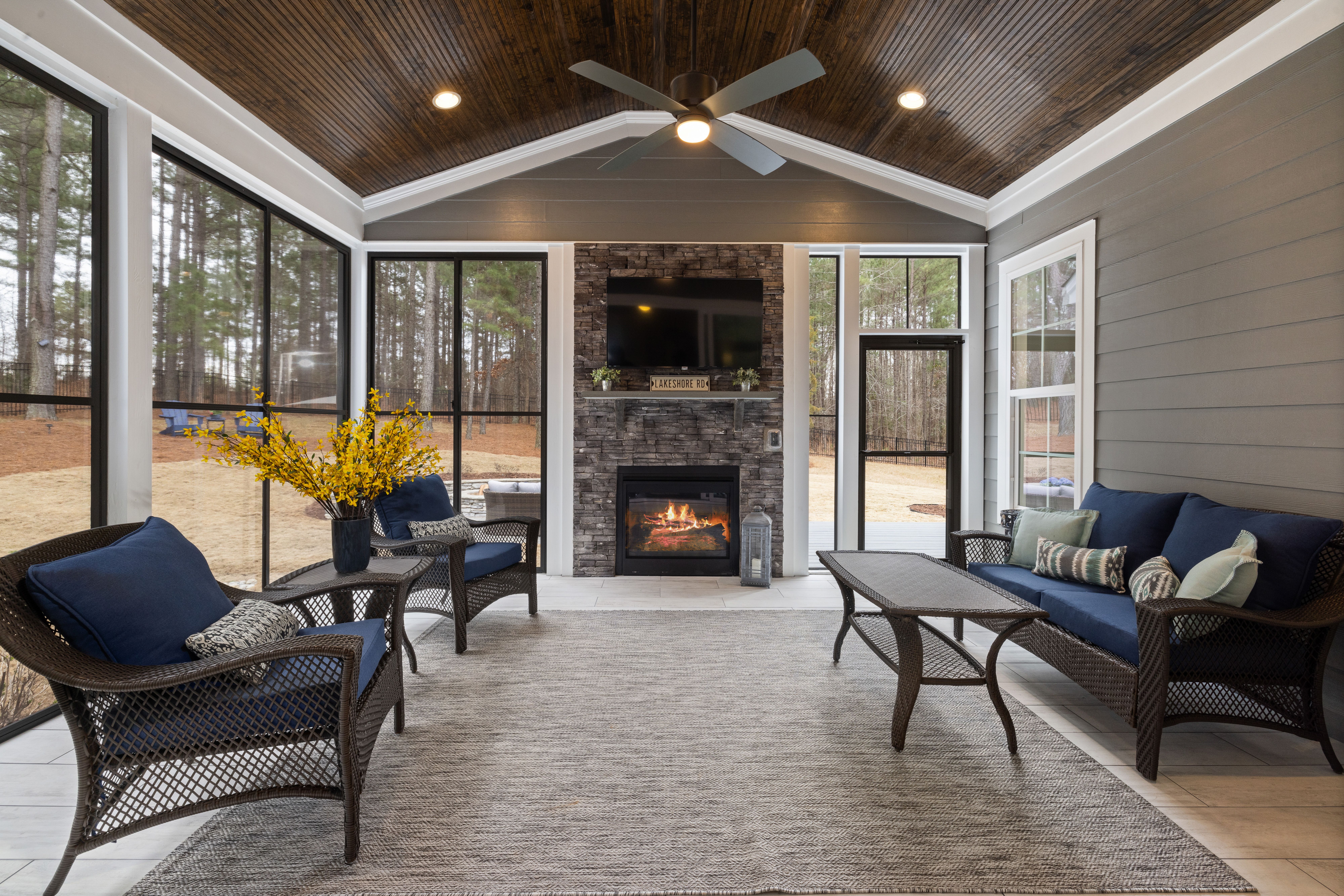 Elegant enclosed patio with fireplace and comfortable seating