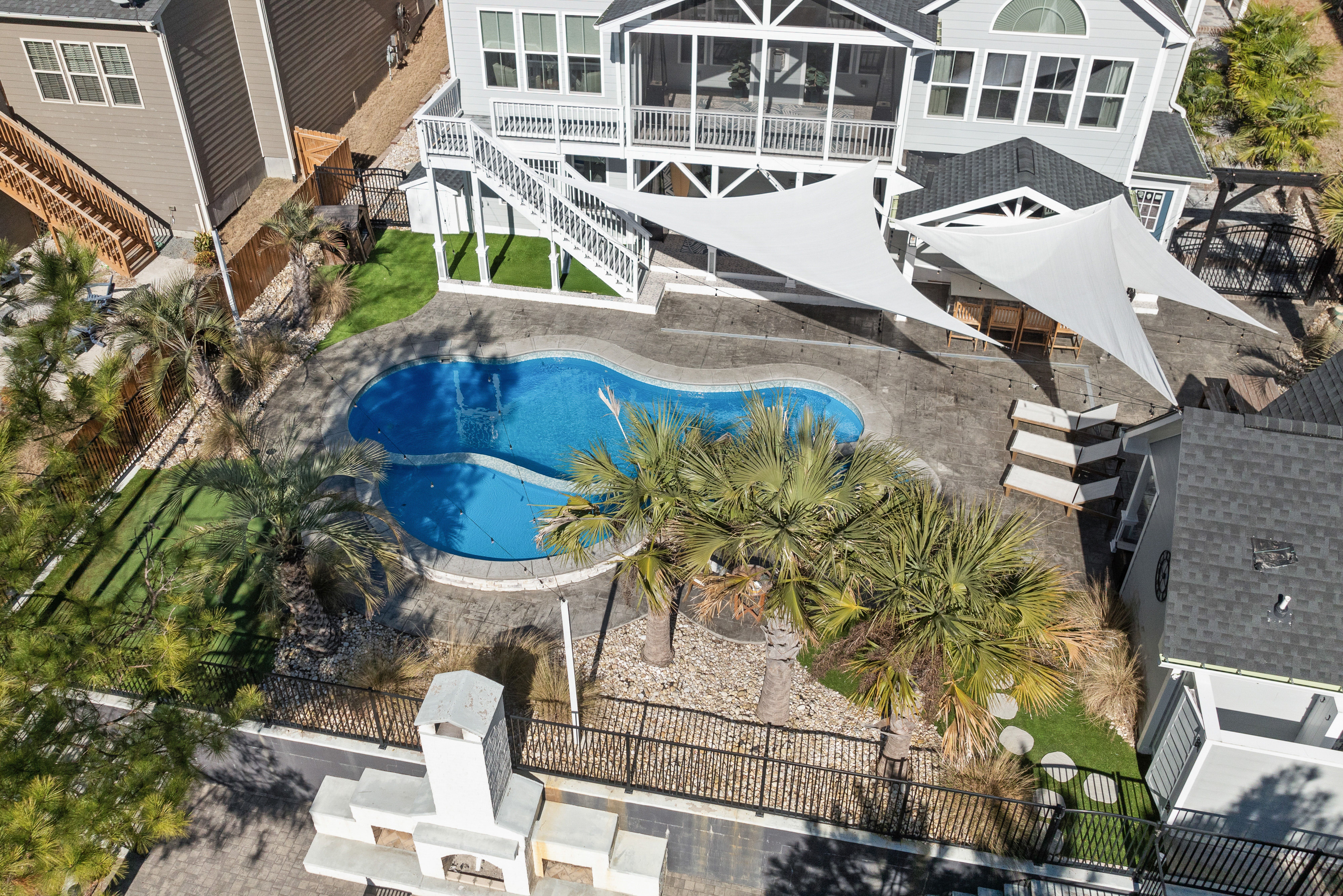 A triangular shade sail installed over a residential garden area