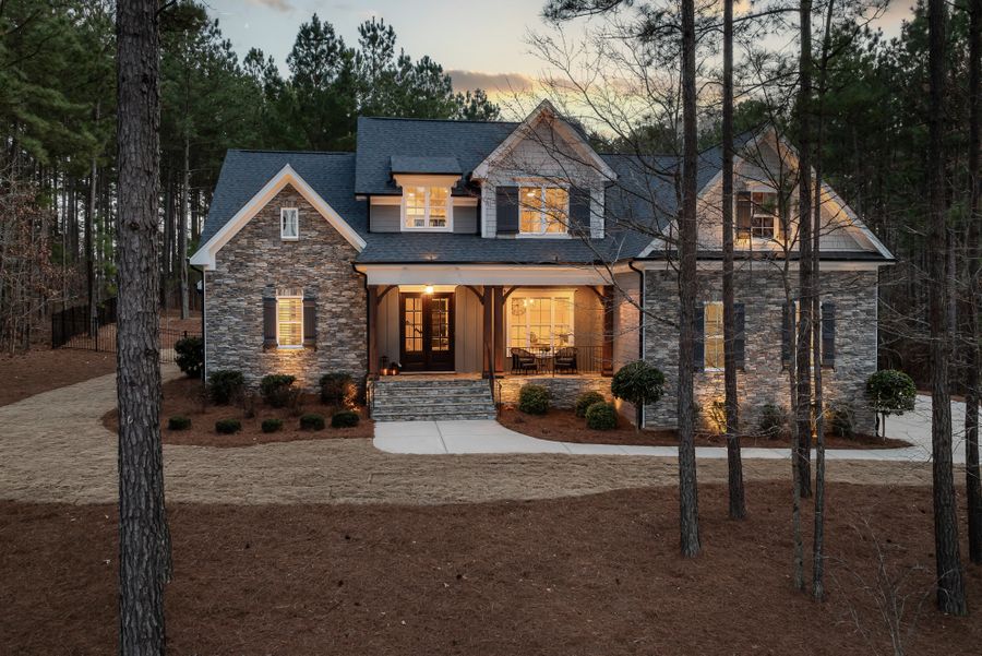 Stone house among pines at dusk