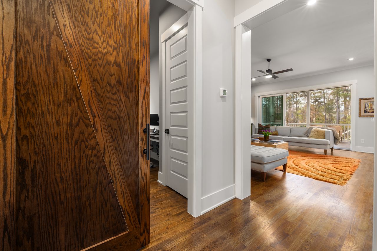 Dark wood sliding door in a bright living room
