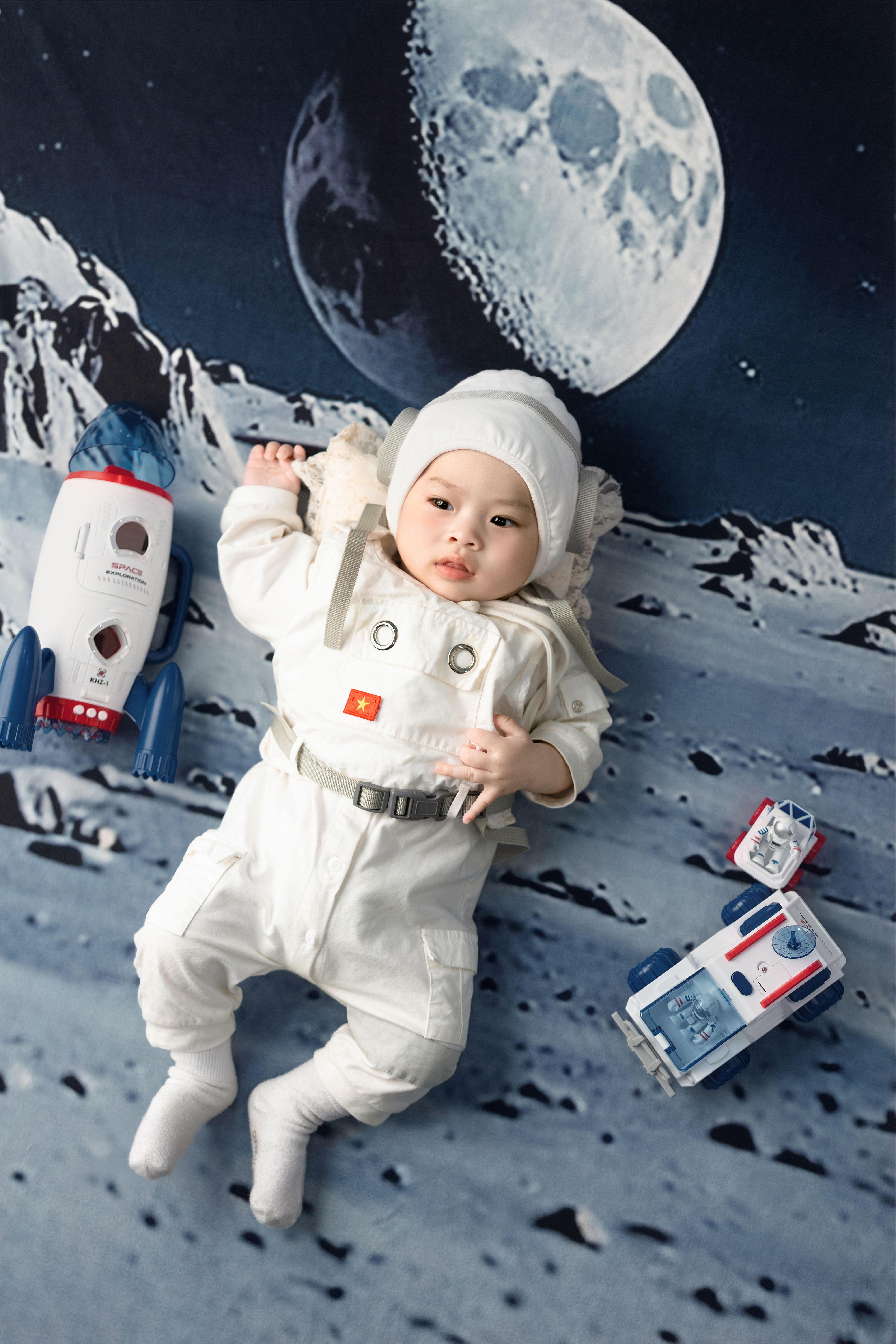 Cute Baby in Astronaut Costume with Toy Rockets · Free Stock Photo