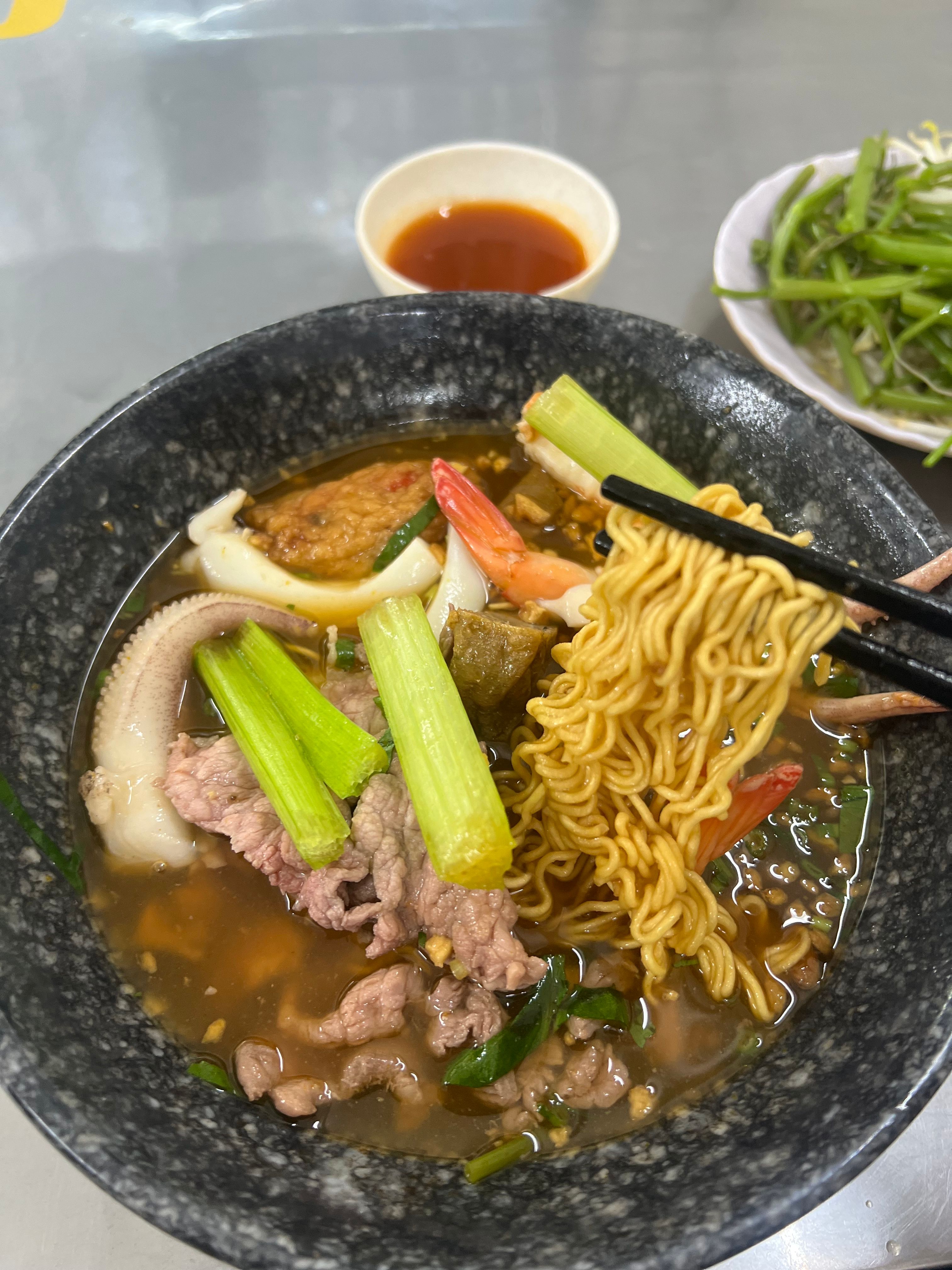 Savor this Vietnamese seafood noodle soup with fresh vegetables and shrimp in a rich broth.