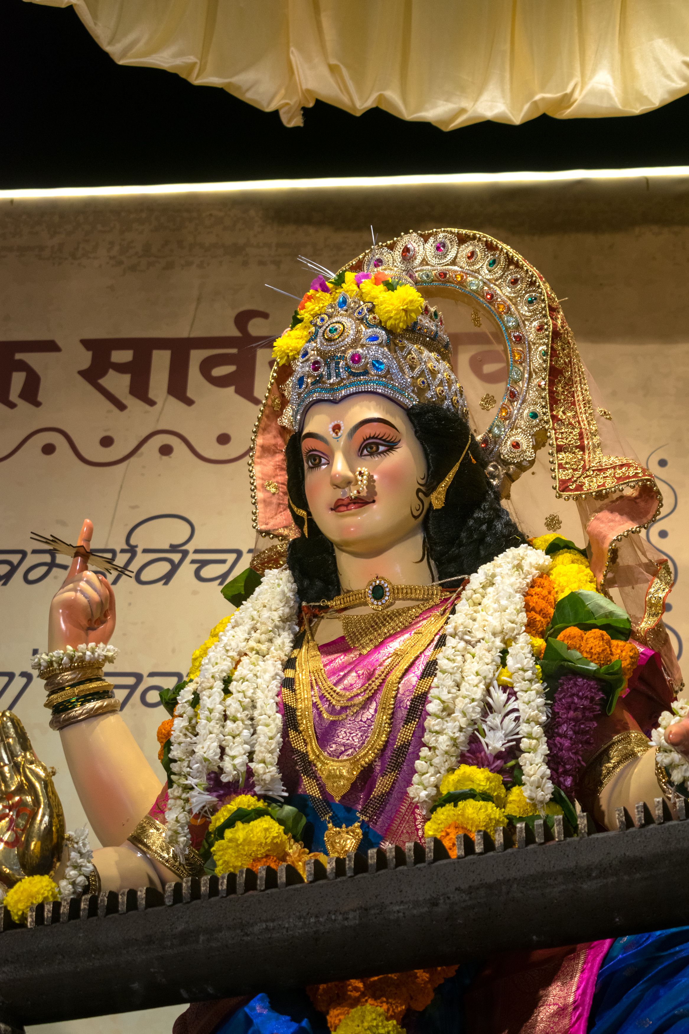 A beautifully decorated idol of Goddess Durga with floral garlands, highlighting the Navratri festival in Mumbai, India.
