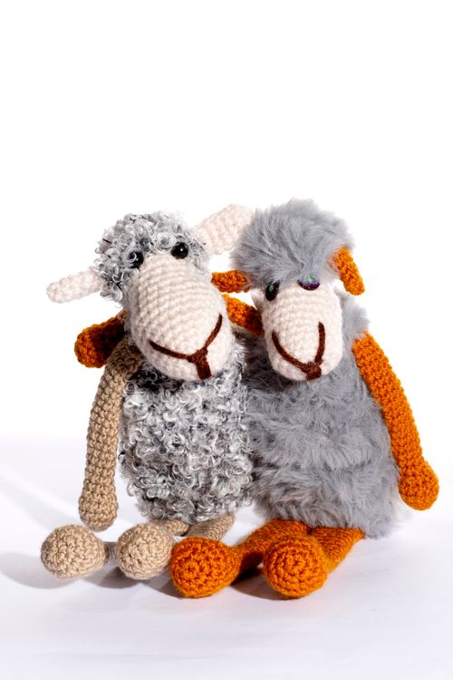 Free Adorable knitted sheep toys with woolly texture and orange limbs, perfect for children's decor. Stock Photo