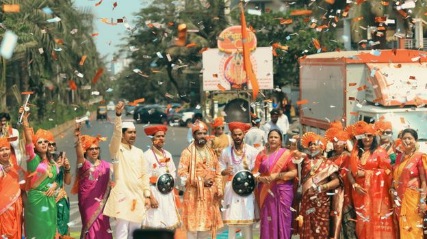 A lively Gudi Padwa festival parade with traditional Marathi attire on a Mumbai street.