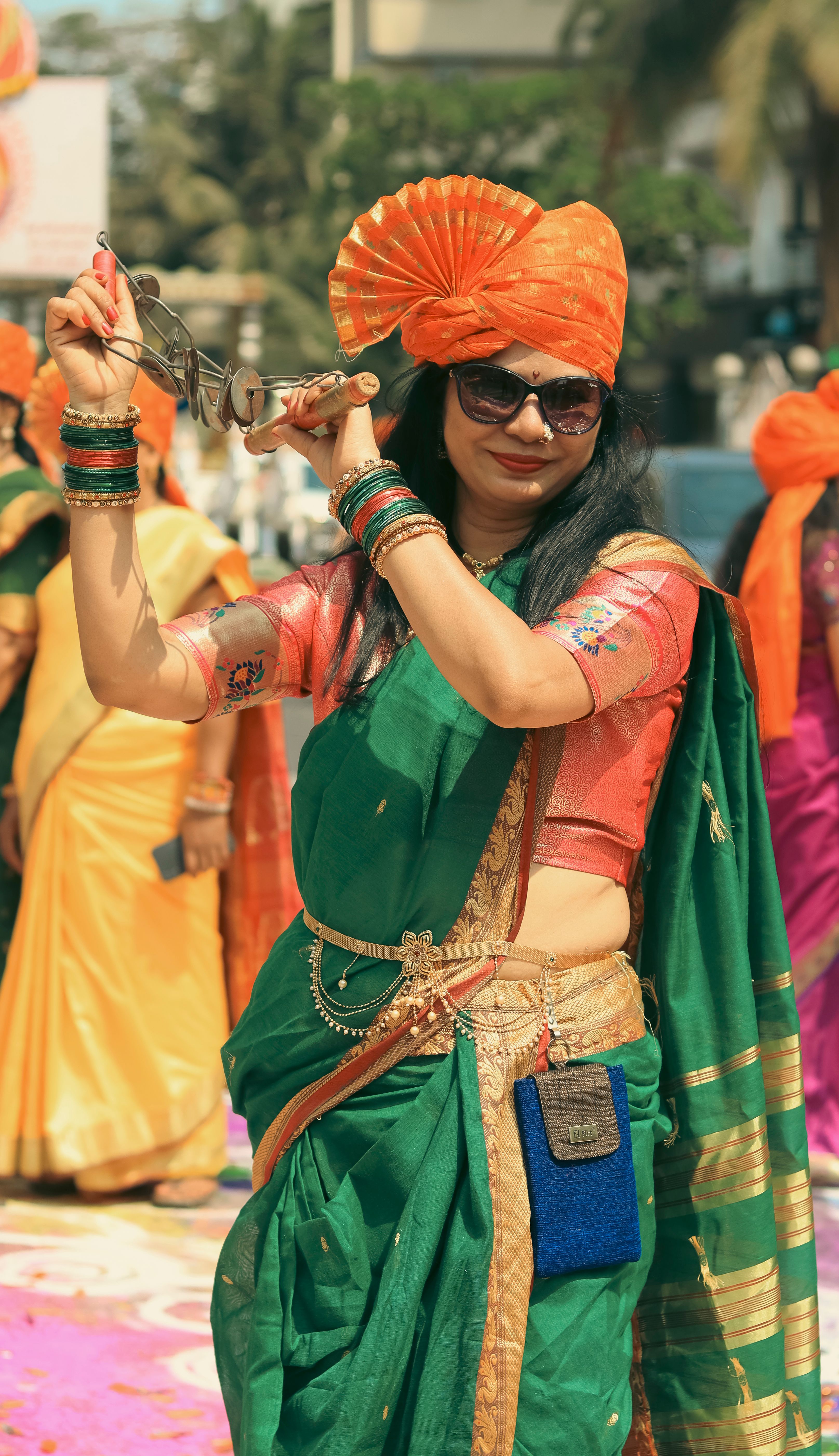 Joyful Indian woman in traditional attire participating in a vibrant street celebration in Mumbai.