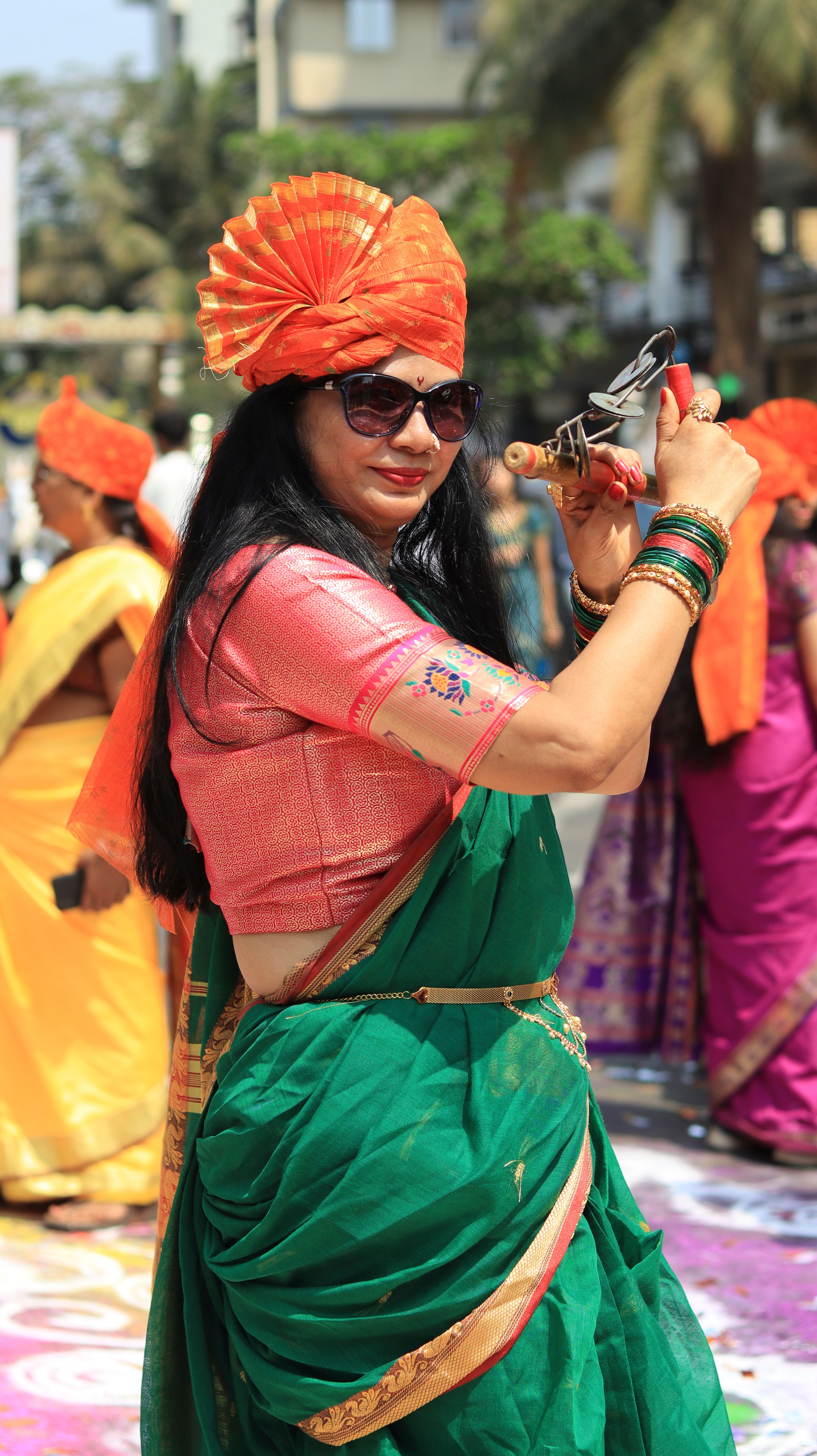 Vibrant celebration of Gudi Padwa with women in traditional attire dancing in Mumbai, India.