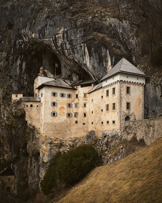 Historic Predjama Castle carved into a cliff in Predjama, Slovenia, showcasing medieval architecture.