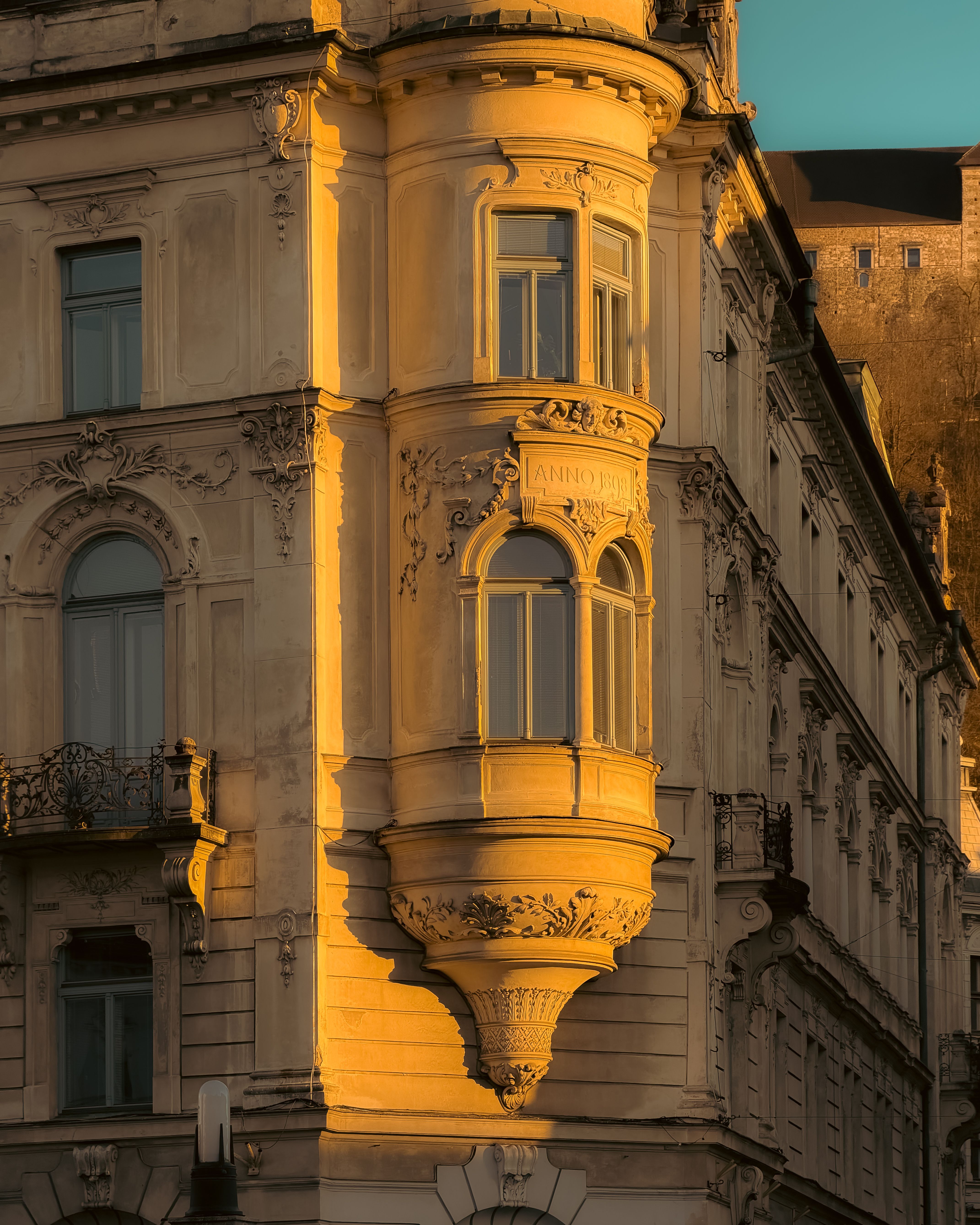 Elegant architectural details on a historic building facade in Ljubljana city center during sunset.