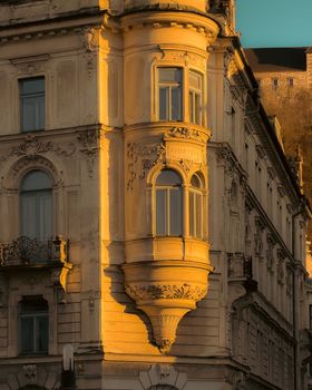 Elegant architectural details on a historic building facade in Ljubljana city center during sunset.