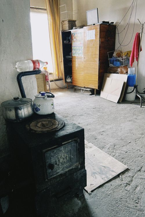 Free Cozy rustic room in Talgar, Kazakhstan featuring a traditional stove and homey interior. Stock Photo