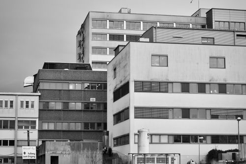 Free A monochrome depiction of a modern urban building complex with geometric lines. Stock Photo