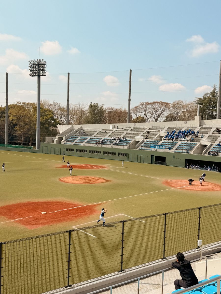 Baseball park with the infield and stands on a game afternoon