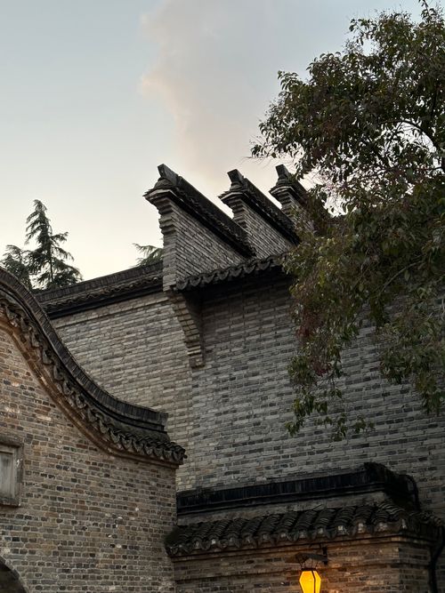 Free Evening view of traditional Chinese architecture with detailed bricks and twilight sky. Stock Photo