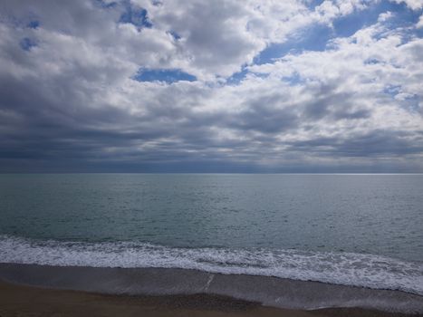 Calm ocean waves and clouds create a serene coastal scene for relaxation.