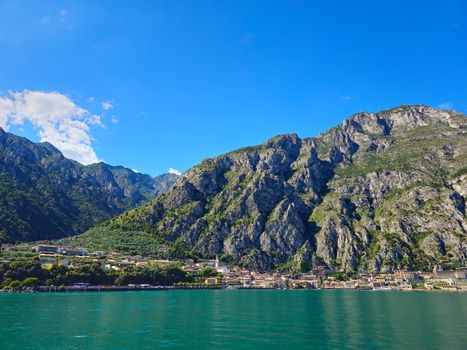 Stunning landscape of Limone sul Garda with mountains and lake under a clear blue sky.