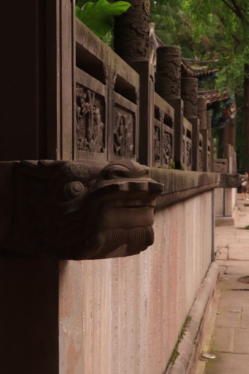 Free Explore the detailed stone carvings of a traditional Chinese temple with lion figures and historic architecture. Stock Photo