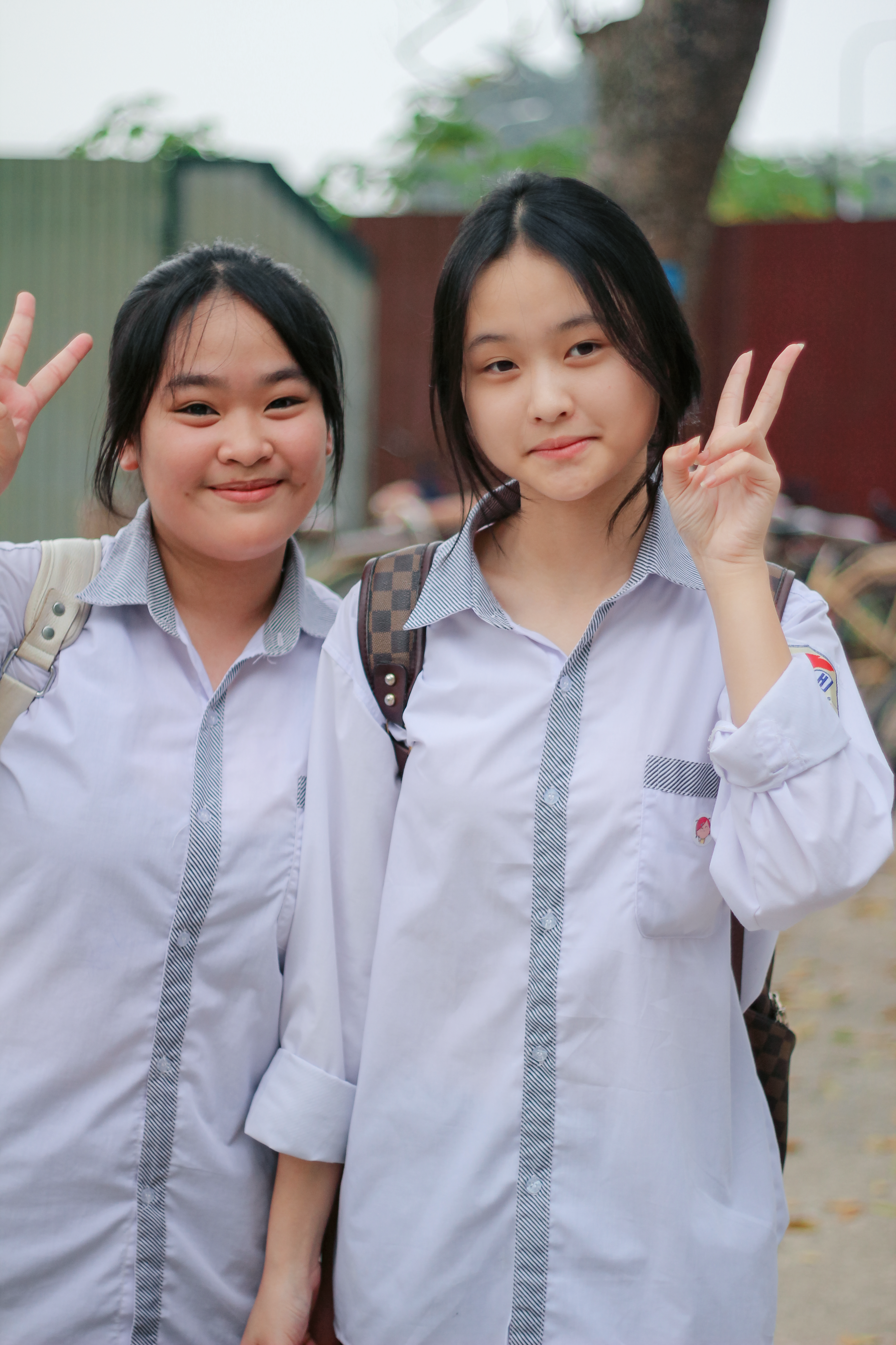 Two Students Smiling and Posing Outdoors · Free Stock Photo