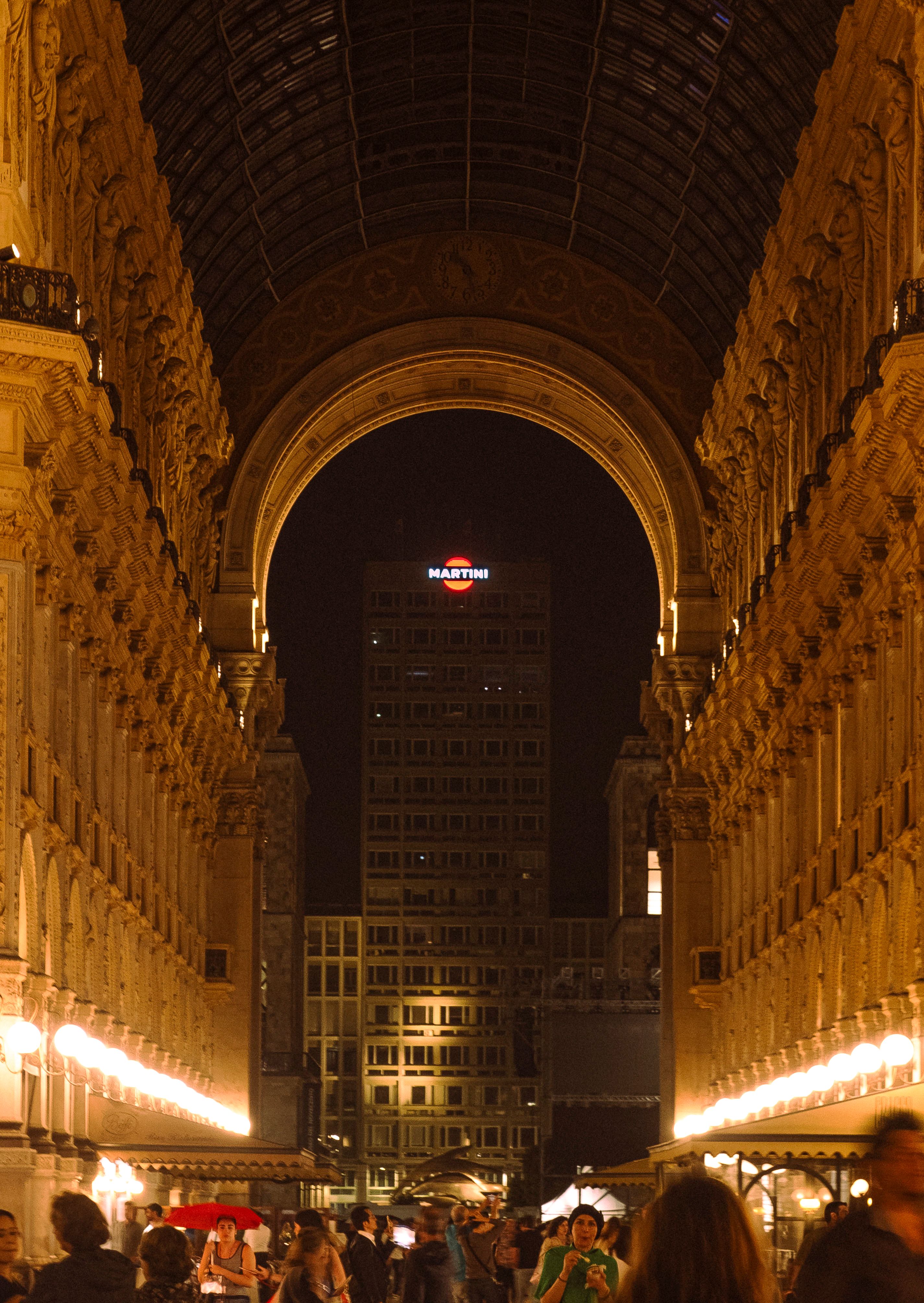 Stunning night view of Galleria Vittorio Emanuele II in Milan, Italy, beautifully illuminated with archway detail.