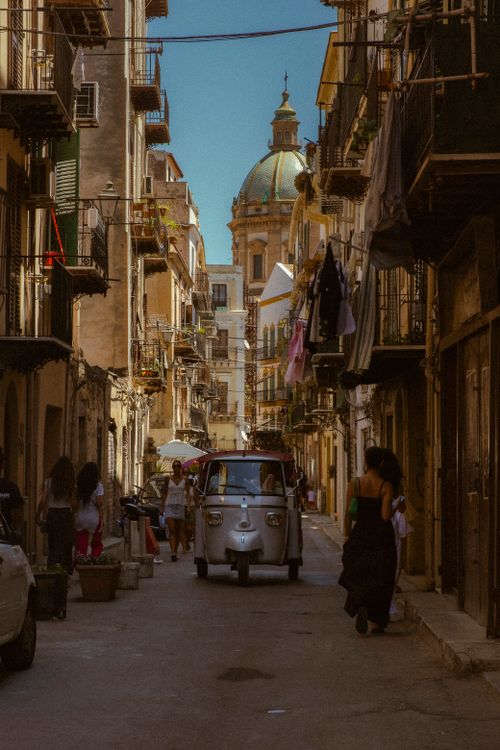 Free Quaint street scene in Palermo, Sicily with vintage vehicles and local architecture. Stock Photo