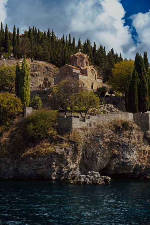 Free Scenic view of the Church of St. John at Kaneo perched on a cliff overlooking Lake Ohrid in North Macedonia. Stock Photo