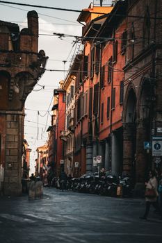 Picturesque view of a historic Italian street with rustic architecture and warm lighting.
