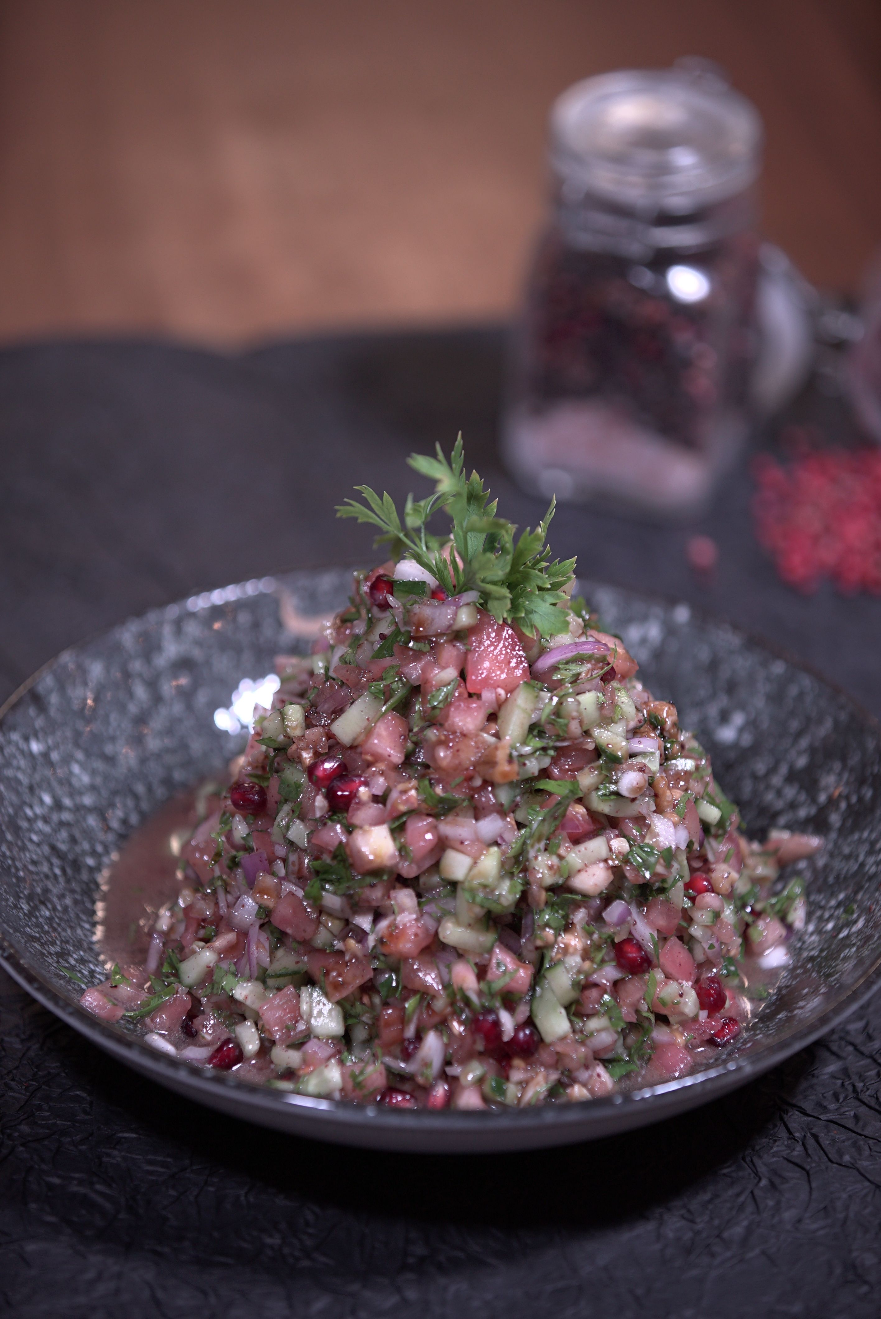 Vibrant vegetable salad with herbs and spices in a decorative bowl, perfect for healthy eating concepts.